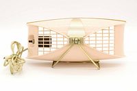 Top view of a vintage pink metal cage table lamp with gold metal parts and attached beige power cord.