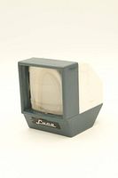 Front view showing grey and white plastic casing with magnifying lens and Luna logo plate.