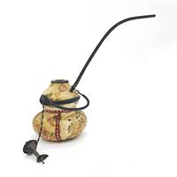 Photo of a vintage ceramic pipe with a double-gourd shape, floral painted decoration, black metal handle and a long slender black stem. Chain hangs with attached metal accessory.