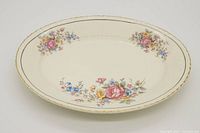 Full view of the vintage oval serving platter showcasing floral design and gold rim.