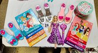 Full lot showing Rapunzel doll, shoes, books, wand, and music box