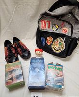 Complete lot showing backpack, shoes, ceramic bowl, and three Harry Potter cassette audiobook sets in original boxes.