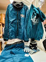 Photo showing reversible jacket, hoodie, fleece pants, gloves and knit hat displayed together