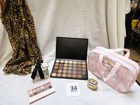 Full lot shown including leopard print scarf, two eyeshadow palettes open, pink floral makeup bag, 3-piece Beekman soap set, and silver plated decorative box