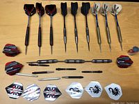 Top-down view of all three dart sets arranged in rows with accompanying shafts and extra flights.