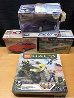Photo showing all four boxed items: Revell Sting Ray III, Probe GT, '67 Corvette Coupe model car kits, and Mega Construx Halo Warthog Rally set.