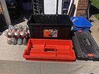 Front view of the opened black plastic toolbox dolly showing the orange tray and the mounted clear dome lights alongside.