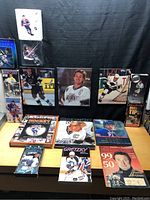 Lot includes books, framed photos, trading cards, magazines, and a collectible figure of Wayne Gretzky.