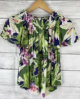 Front view of floral blouse on hanger, showing off-shoulder design and multicolor floral print.