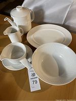Seven-piece white Athena dinnerware with coffeepot, creamer, bowls, and plates with ribbed pattern