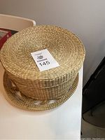 Photo of the whole basket with lid and tray showing its size and form on a white table.