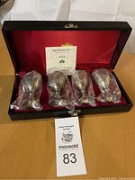 Four silver goblets in black presentation box with red interior lining and certificate of authenticity.
