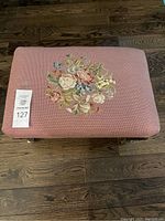 Top-down view of the pink foot rest showing the full rectangular shape and embroidered floral design.