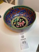 Top angled view showing the interior floral painted decoration inside the ceramic bowl.