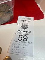 Photo of note listing coin counts and totals including 11 quarters, 4 dimes, 4 nickels, and 4 half dollars. Note states no silver content.