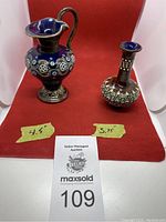 Both miniature Royal Doulton pieces displayed together with height labels and auction tag visible.