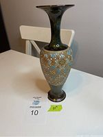 Full view of Royal Doulton vase showing profile and height relative to table and chair