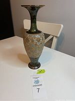 Full view of tall vase showing textured gold and blue floral pattern with green glaze on neck and base