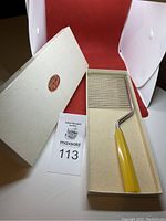 Schneider cake breaker tool in original box with instruction manual and lot number card.
