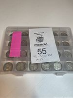 Closed plastic coin case holding 48 quarters with auction label