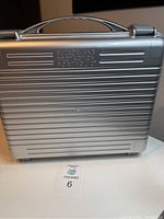 Silver plastic case with handle and Protection Portfolio inscription on front.