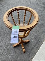 Full view of the wooden plant stand, showing the circular top with spindle supports and tripod base, MaxSold auction tag visible.