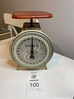 Full view of the Wayrite vintage scale showing the round dial, red platform, and cream metal body.