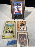Four hockey cards including three Bobby Orr cards and one Brian Leetch card, arranged for clear view