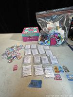 Full lot arranged on table with Amiibo cards, tokens, ziplock bag of accessories, and decorative box