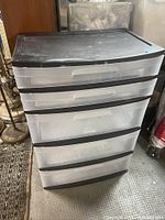 Front view of Sterilite 5 drawer storage tower showing black top and clear drawers.