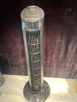 Front view of the tower fan showing the grill, control buttons on top, and the Westinghouse logo.