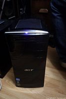 Front view of Acer tower with illuminated power indicator and logo