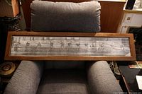 Full view of the large framed panoramic photo print of the hockey team in oak frame on armchair