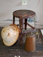 Full view of stool, helmet, and kettle showing condition and size