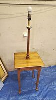 Full view of vintage Ethan Allen side table with built-in lamp and exposed bulb