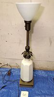 Full view of the vintage Lenox lamp showing the white porcelain base, brass accents, milk glass shade, and cord.