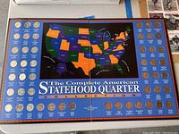 Overview photo of full collection in display folder with quarters surrounding U.S. state map.