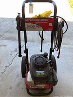 Front view showing pressure washer with Honda motor and control panel signage.