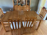 Overview of rectangular table top with six chairs in place