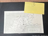 Photo showing a vintage printed map titled 'Reference Map for the Central Garage Motor Tours' with a yellow note indicating dates and locations: 1930 England and 1936 Germany.