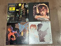 Four David Bowie vinyl record albums laid out, showing album cover artwork and condition.