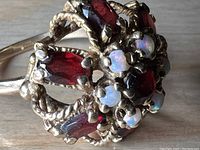 Top-down view of cluster showing garnets and opals set in twisted gold rope framework