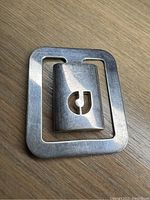 Front side of silver metal money clip with CJ logo cutout on insert