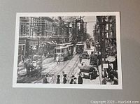 Single photo of a black and white print depicting Yonge Street with multiple streetcars and city buildings, dated mid-20th century copy.