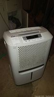 Full view of the white Frigidaire dehumidifier with digital display panel on top and air intake front grille.
