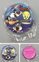 Front and back views of a sealed 1995 Looney Tunes button pin showing Bugs Bunny, Tweety, Daffy Duck, and Sylvester on a blue background with pink back and pin fastener.