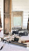 Wide view of the lot showing the wooden wash stand, two Sony radios, Pentax PC-550 camera box, tripod, and vintage knife on a table.