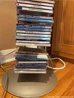 Close-up of CDs stacked in the metal rack showing titles such as Lena Horne, Diana Krall, Dippi, and various others.