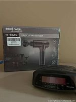 Western clock radio and Bodi-Well muscle massager box in background