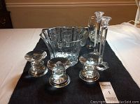 Photo showing Mikasa ice bucket, Shannon crystal candle sticks, smaller candle sticks, and glass ashtray arranged on a table